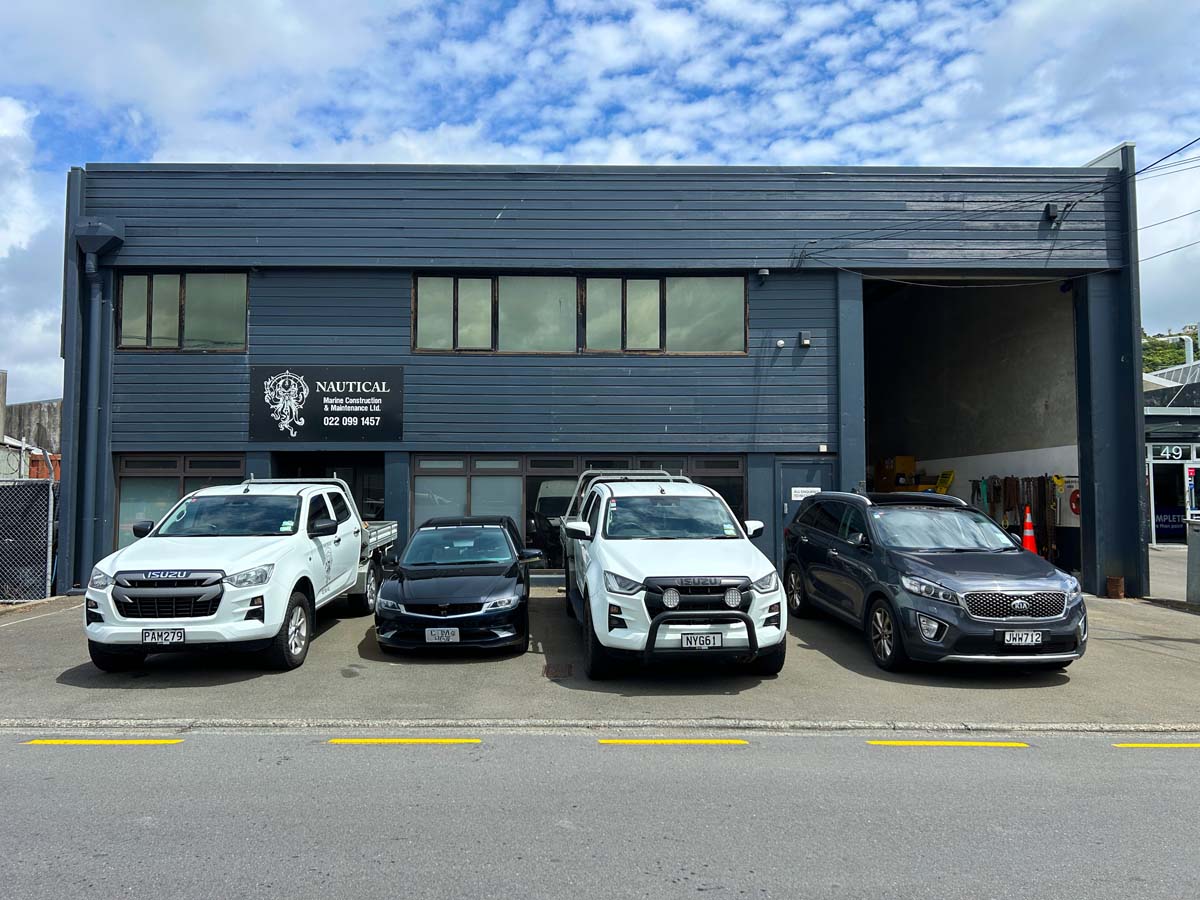 Modern vehicle workshop with White Lion signage and parked cars in Wellington.