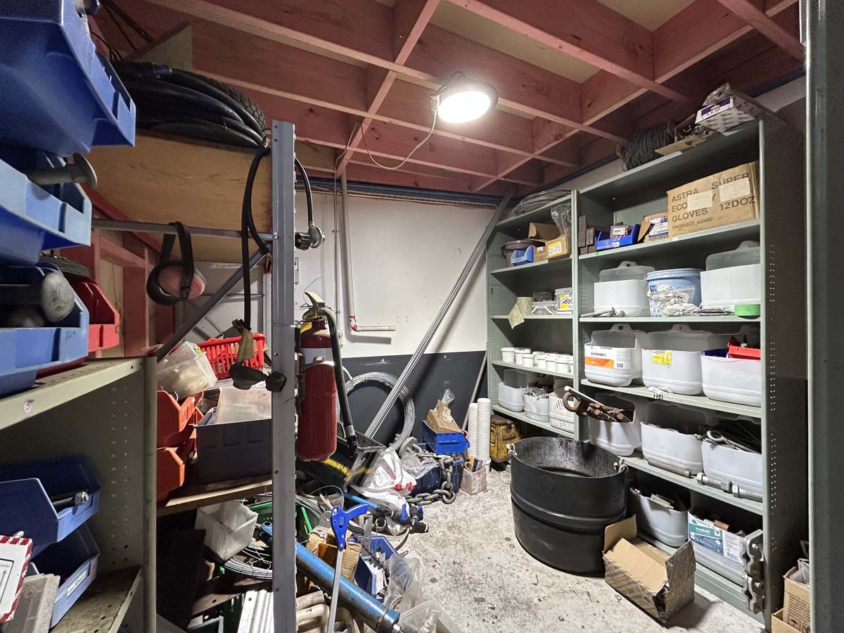 Interior of White Lion workshop with organized shelves and tools.