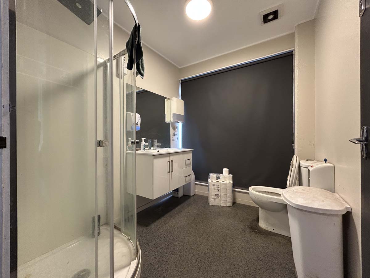 Modern bathroom with shower, toilet, and vanity at White Lion, Victoria Street.