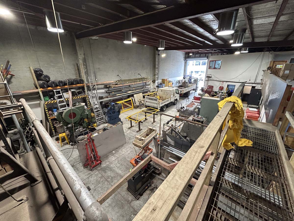 Workshop interior of White Lion at 47A Victoria Street, showcasing woodworking and manufacturing equ.