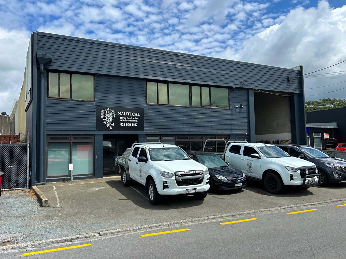 Modern commercial building with White Lion signage and parked vehicles at 47A Victoria Street.
