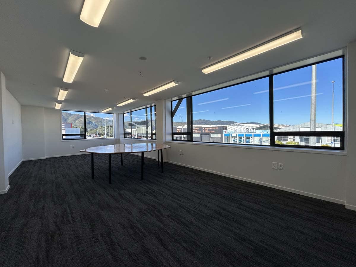 Spacious office interior with panoramic city views and natural light.
