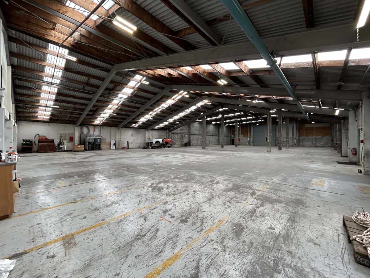 Spacious warehouse interior with high ceilings and industrial lighting at 69 Waione Street.
