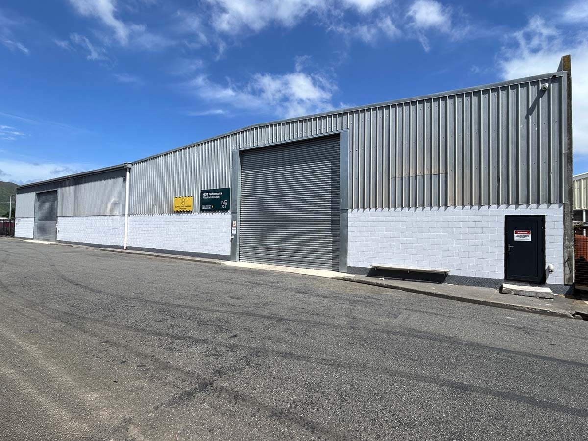 Modern industrial warehouse with metal cladding and roller door at 69 Waione Street.