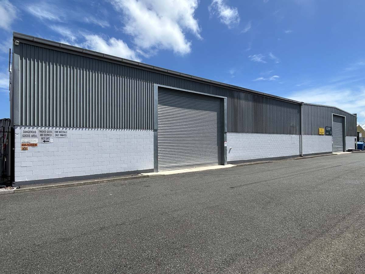 Modern industrial warehouse at 69 Waione Street with metal cladding and roller door.