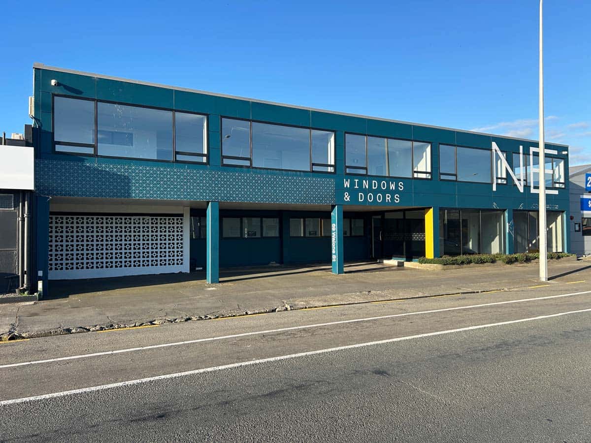 Modern commercial building with large windows and signage for Windows & Doors.