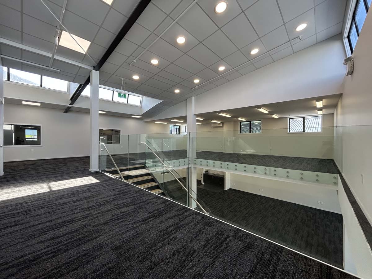 Bright, open-plan office space with glass balustrades and natural light.
