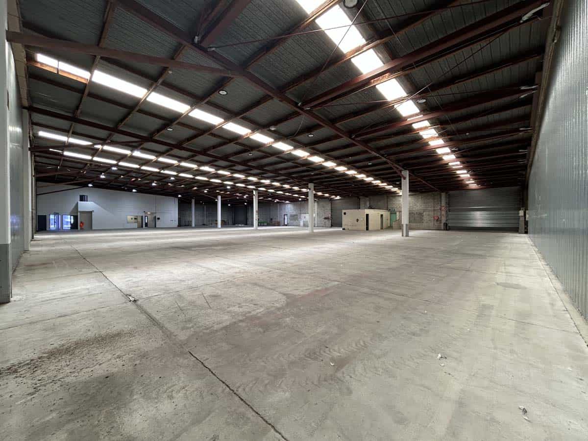 Spacious industrial warehouse with high ceilings and ample lighting at 77 Port Road.