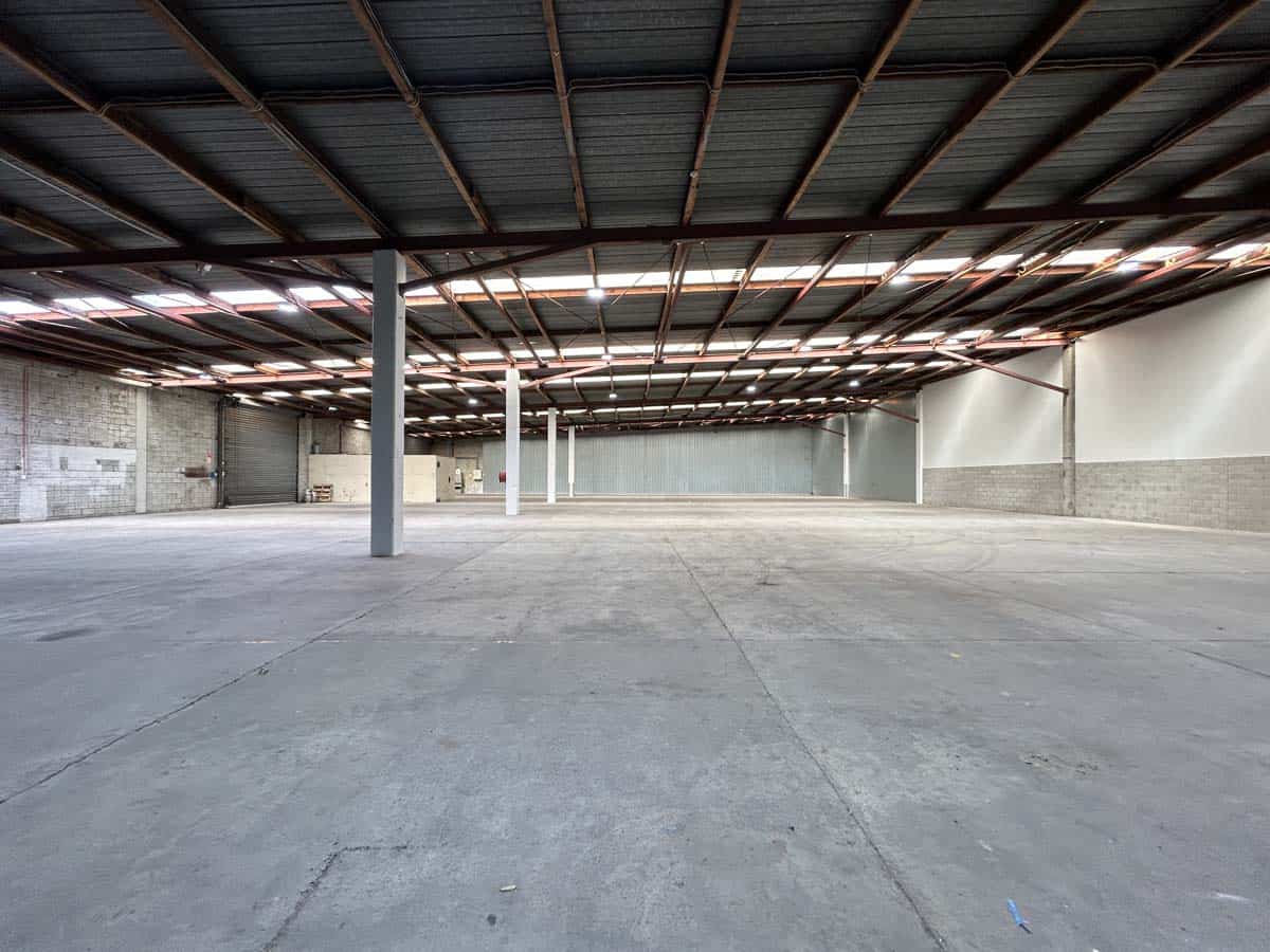 Warehouse interior with high ceilings and open space.
