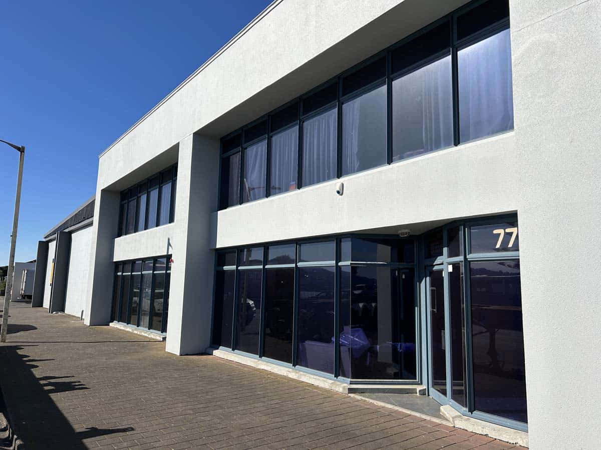 Modern White Lion office building with large glass windows at 77 Port Road.