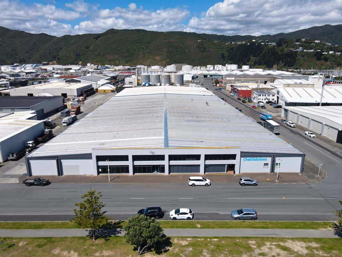 Large industrial warehouse with White Lion signage, located at 77 Port Road, Auckland.