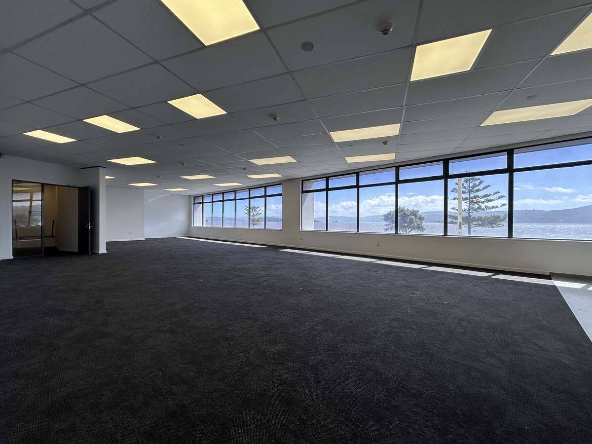 Spacious office interior with large windows and scenic views at 77 Port Road.