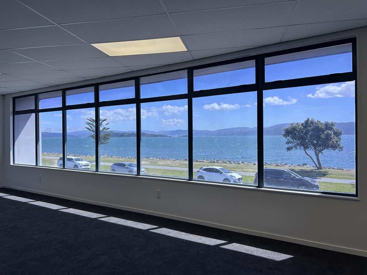 Modern office interior with large windows overlooking Lake Rotorua.
