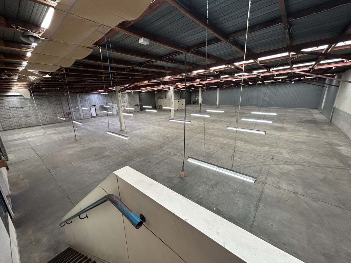 Spacious warehouse interior at 77 Port Road with high ceilings and lighting.
