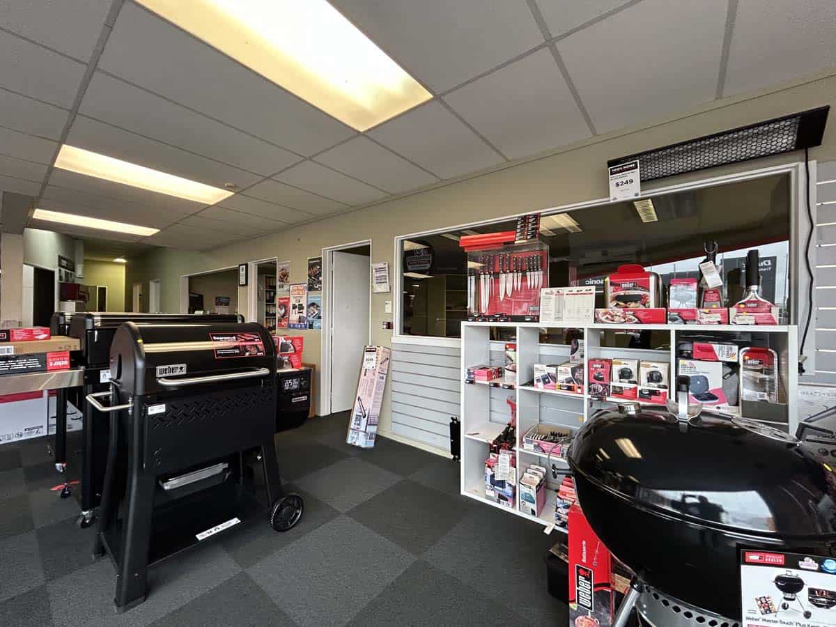 Interior view of White Lion retail store with BBQ grills and accessories.