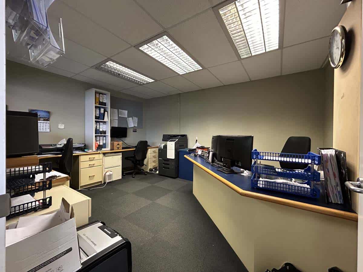 Modern office space with desks, computers, and office supplies at 86 Gill Street.
