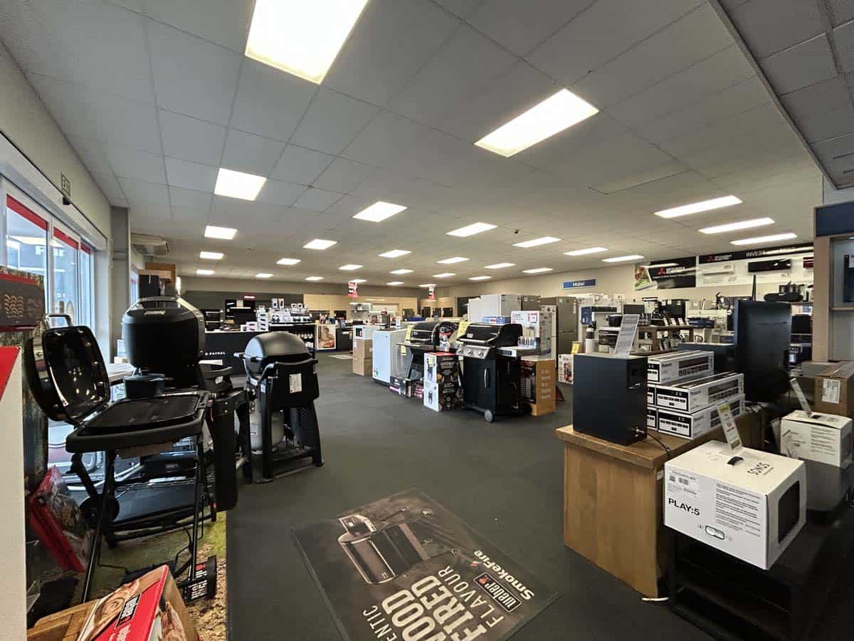 Interior view of White Lion store at 86 Gill Street showcasing office supplies and electronics.