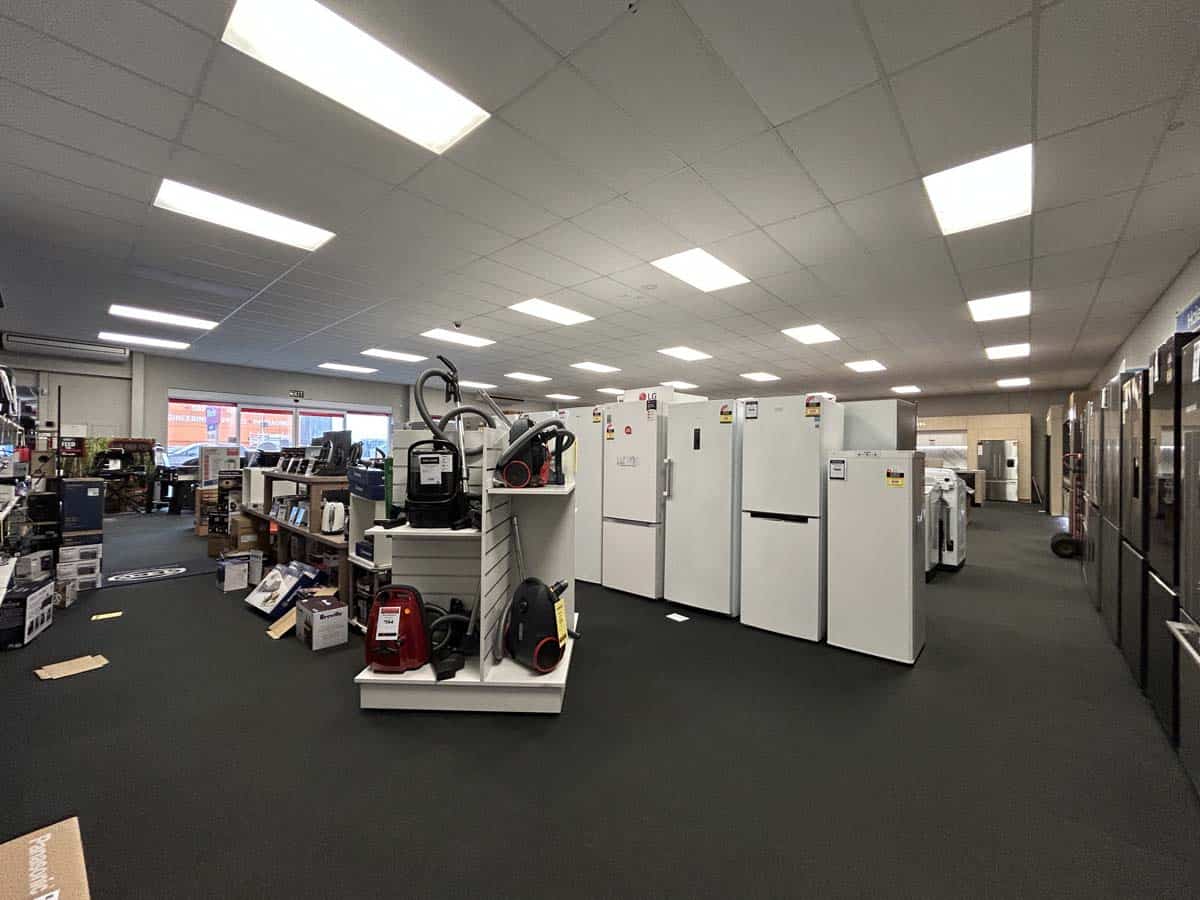 Interior view of White Lion appliance store with refrigerators and household appliances.