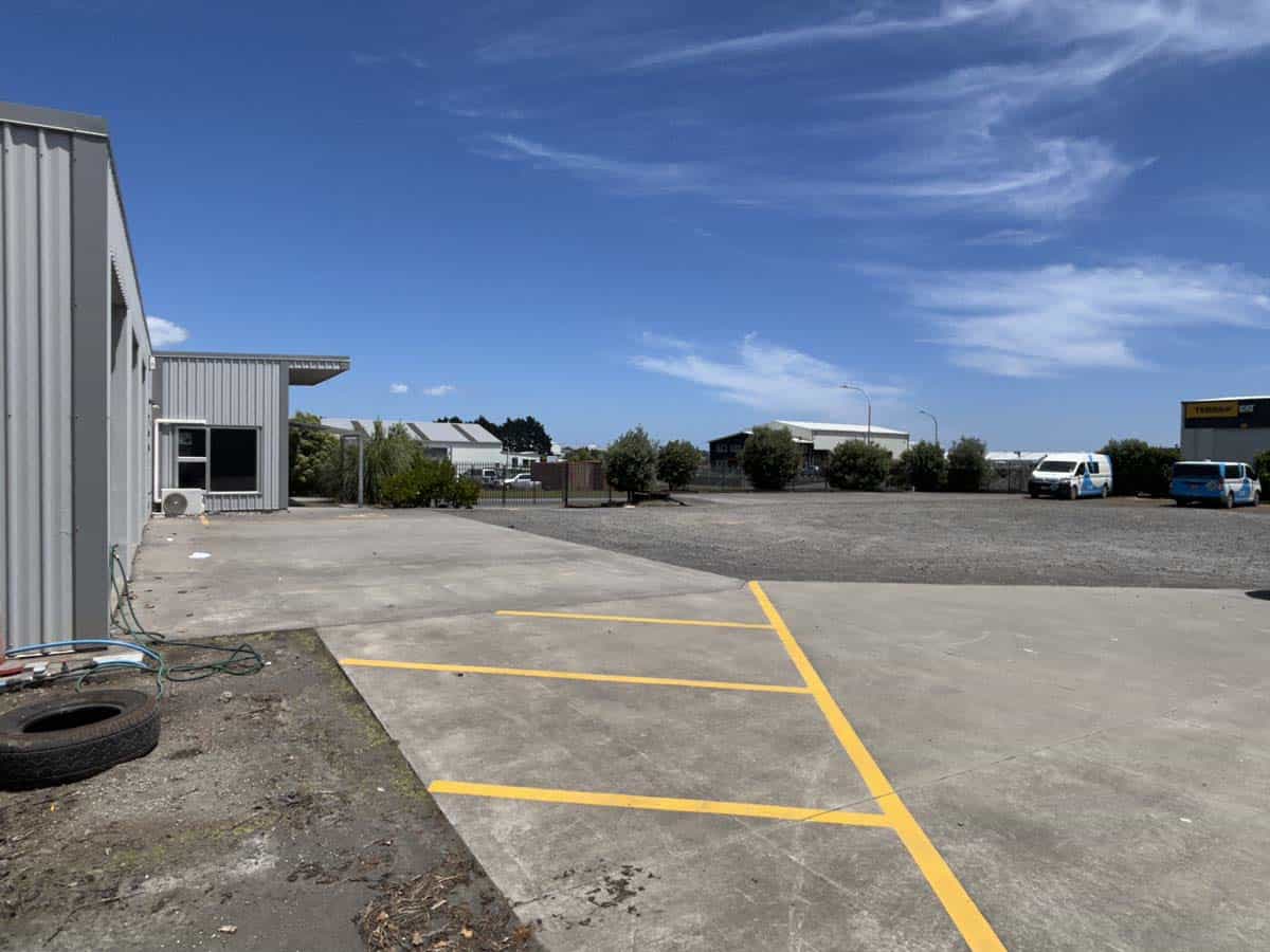 Wide view of commercial parking lot at 76 De Havilland Drive.