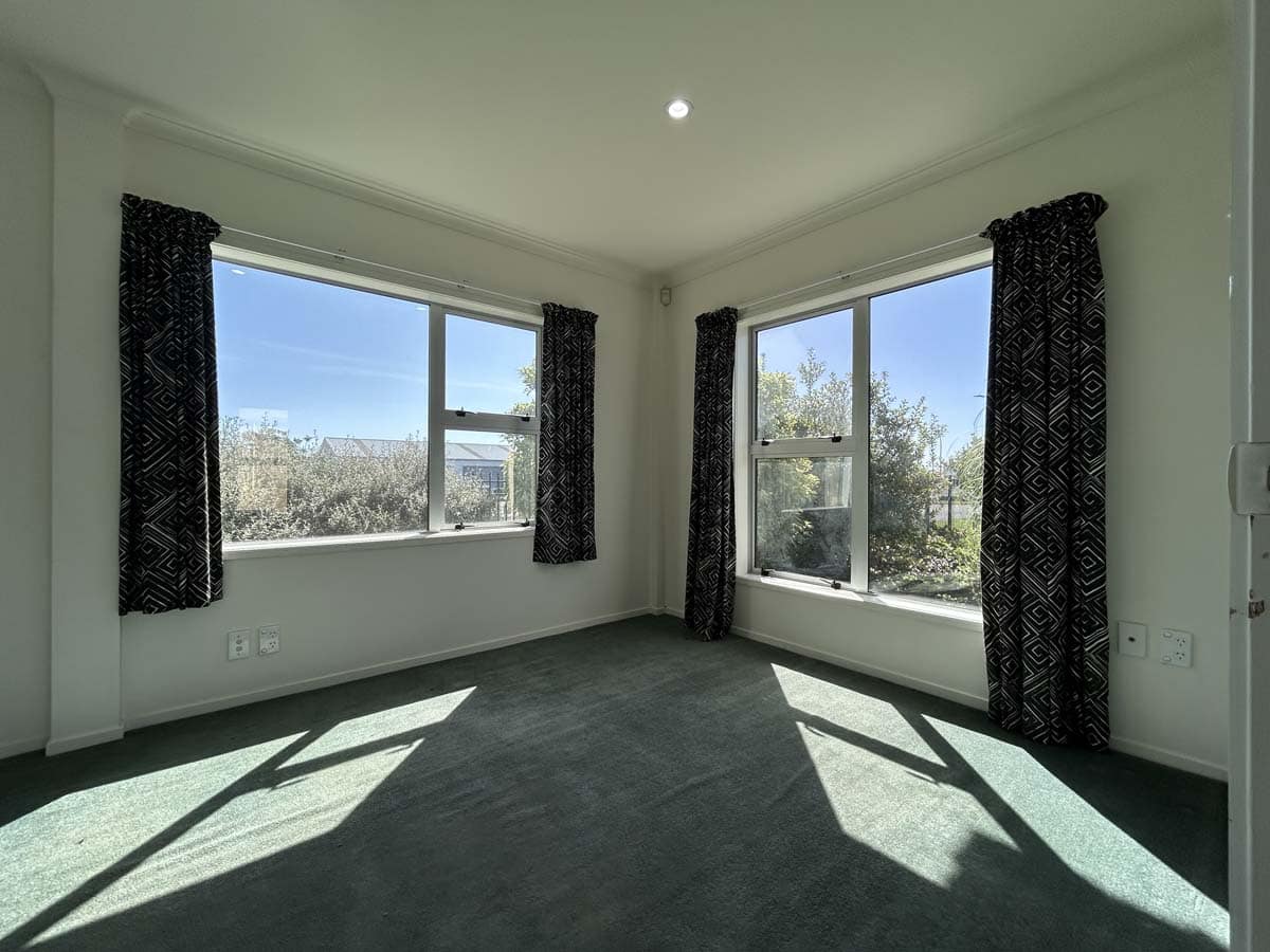 Spacious living room with natural light, large windows, and scenic views at 76 De Havilland Drive.