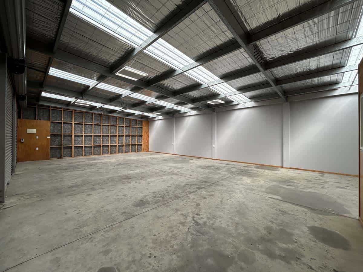 Industrial warehouse interior with high ceilings and skylights at 76 De Havilland Drive.