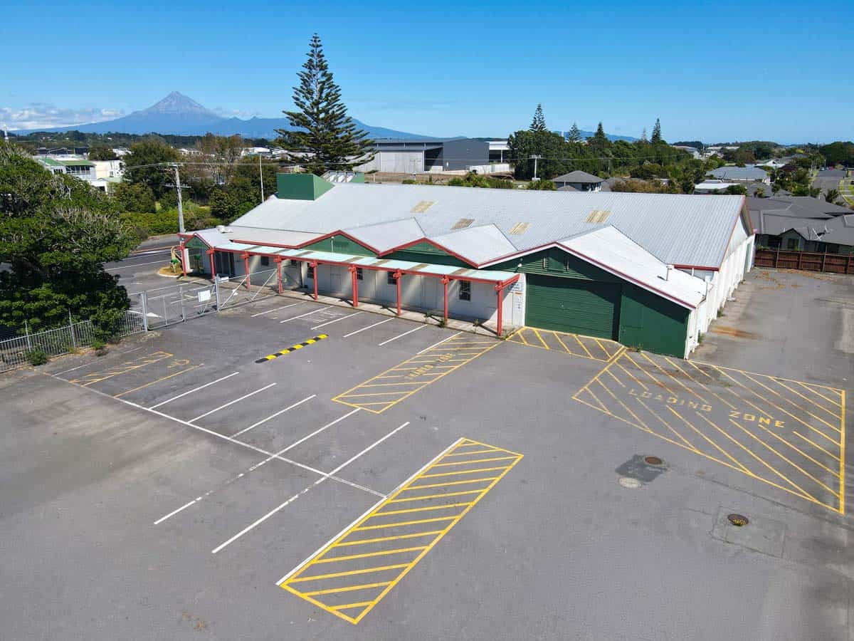 Modern commercial building with parking lot at 1121 Devon Road, White Lion, New Zealand.