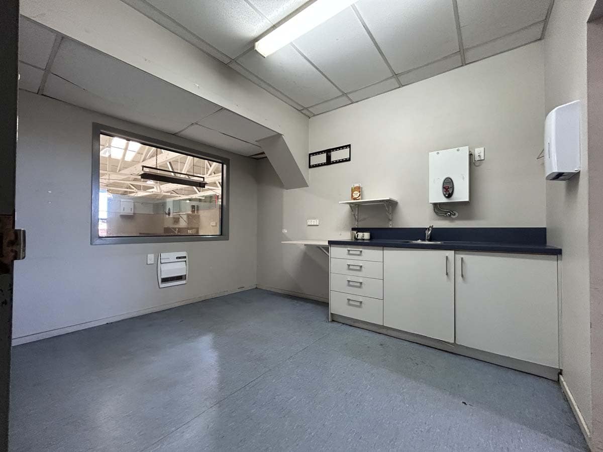 Modern commercial kitchen space at 1121 Devon Road with white cabinetry.