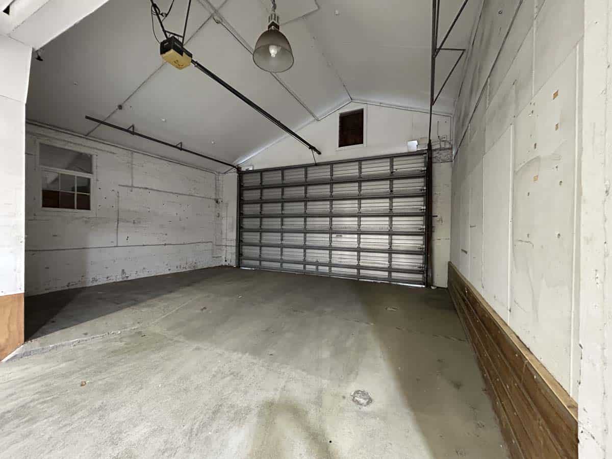 Garage interior with white walls and metal door.