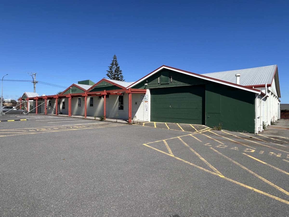 Modern commercial building with green and white exterior at 1121 Devon Road.