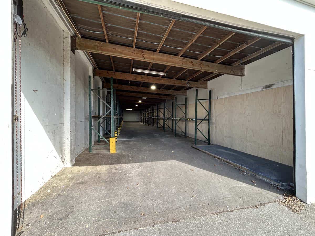 Storage space at 1121 Devon Road with open garage and shelving.