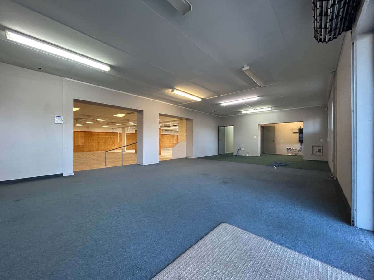 Spacious interior of a commercial property with high ceilings and ample lighting.