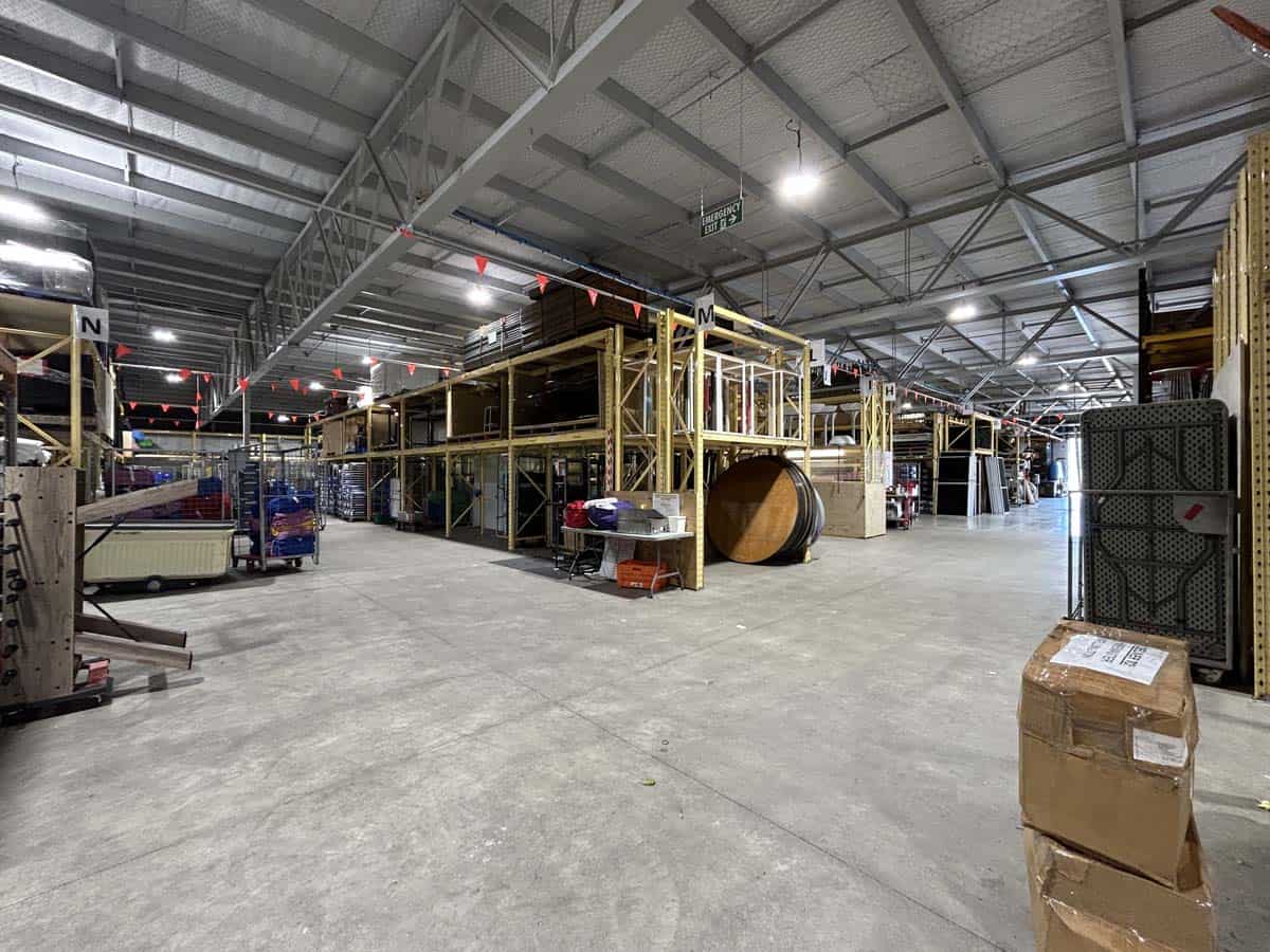 Spacious warehouse interior at White Lion with storage racks and industrial shelving.