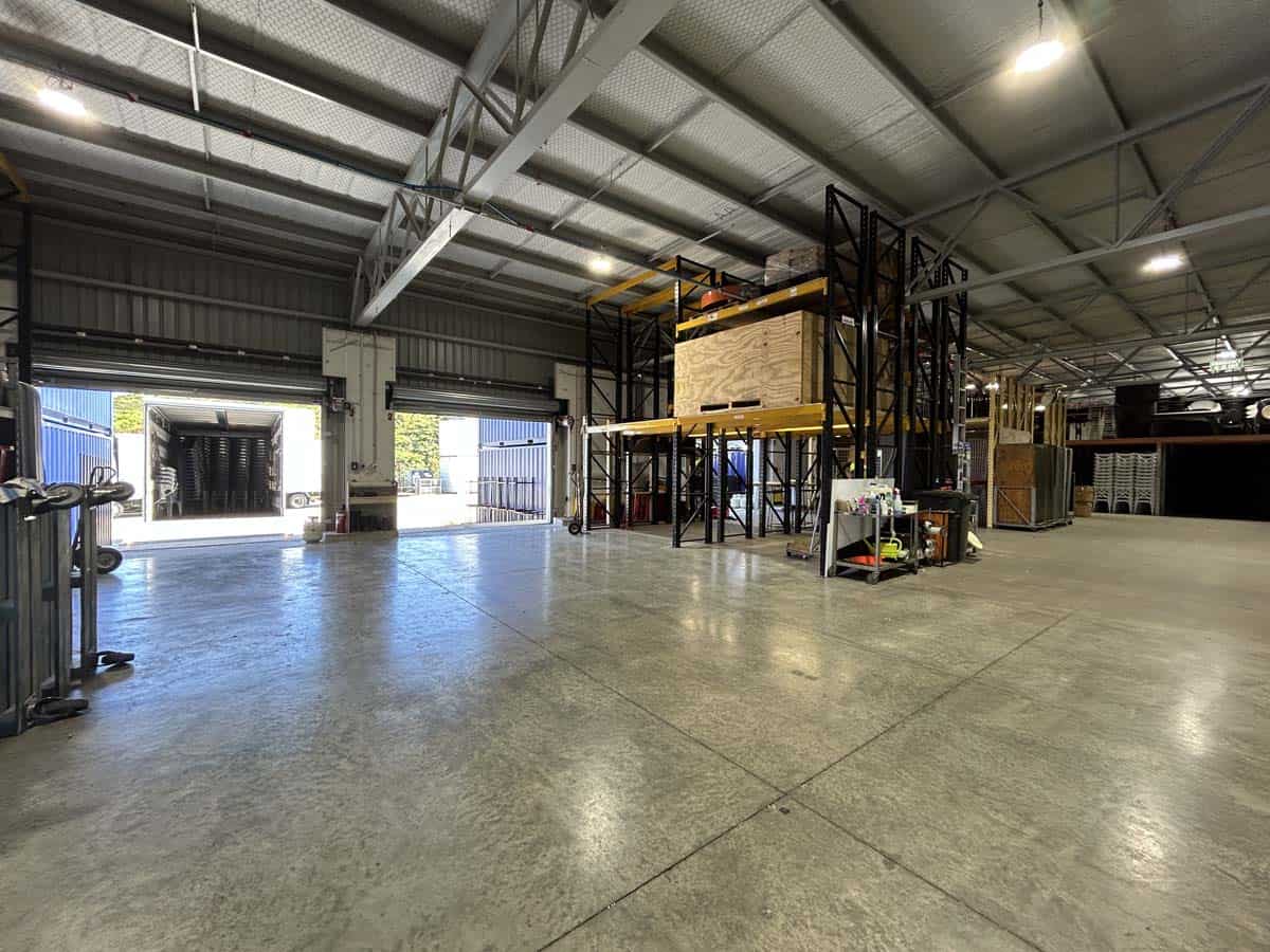 Spacious industrial warehouse with high ceilings and storage racks.