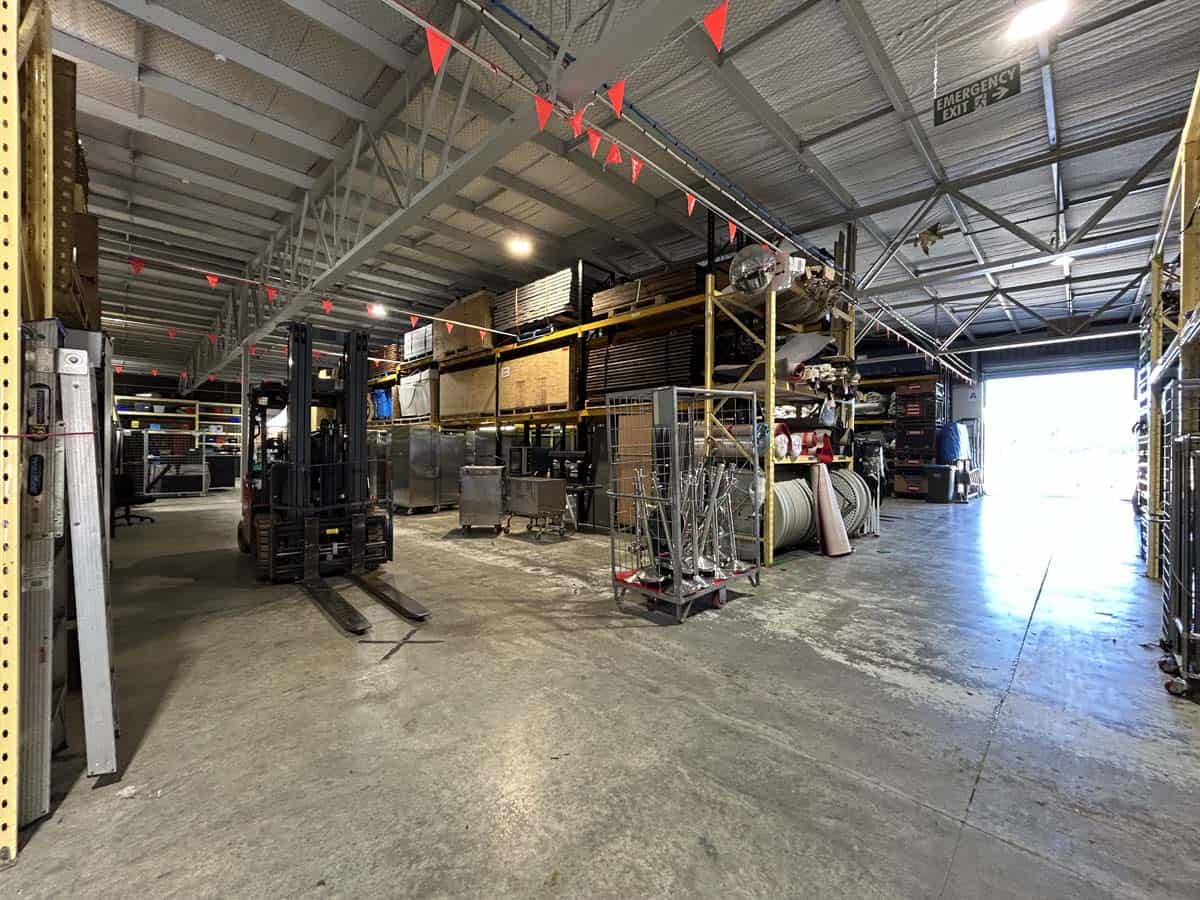 Interior view of White Lion warehouse with storage racks and equipment.