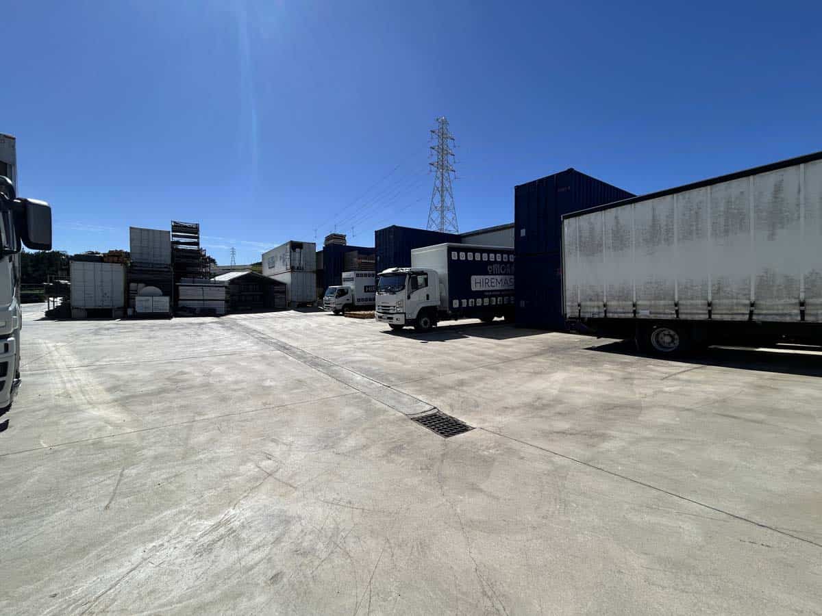 Industrial logistics yard with trucks and containers at 25 Cashew Street.