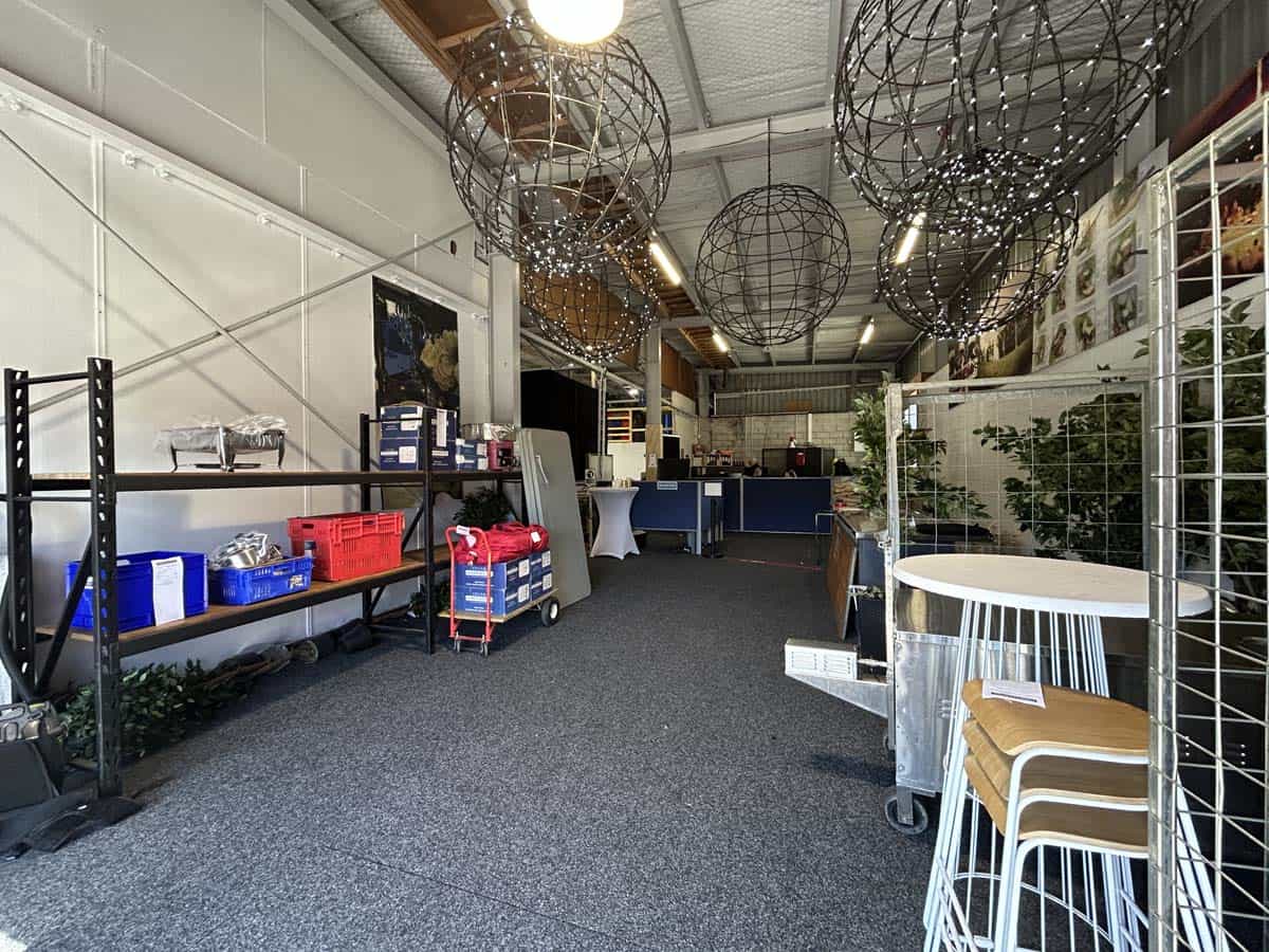 Bright, spacious interior with hanging spherical light fixtures and shelving.