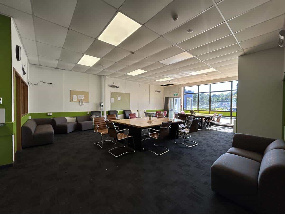 Bright meeting room with large windows and modern furniture.