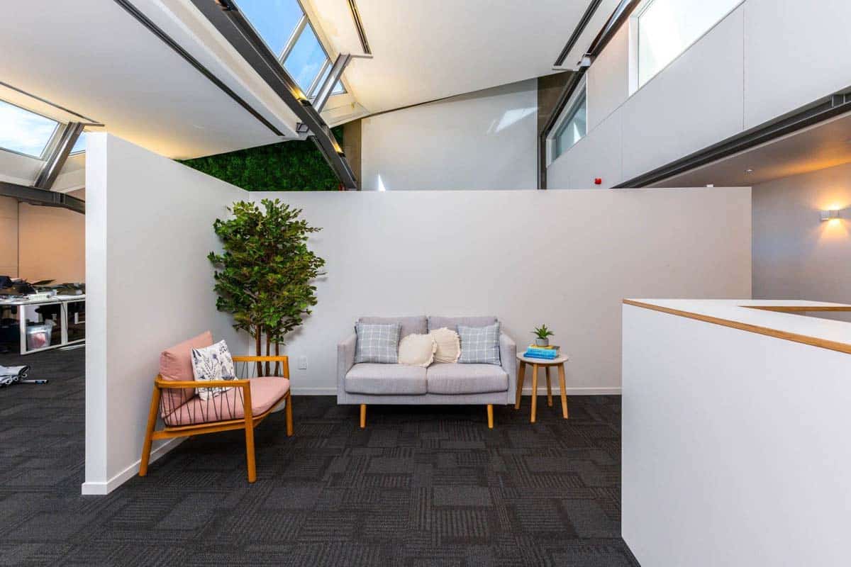 Contemporary office lounge with sofa, armchair, and indoor plant at White Lion, Level 1, 20 Johnsonv.