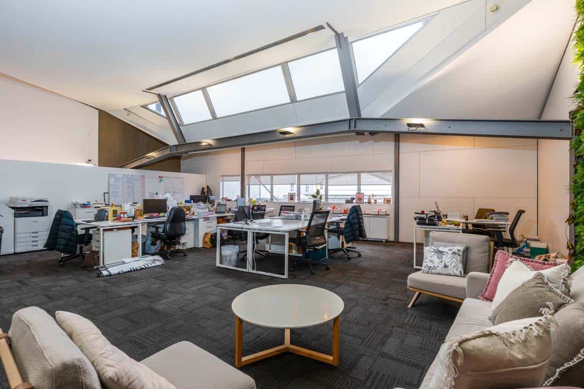 Modern office interior with open workspace and natural lighting.