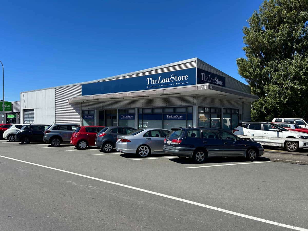 Modern retail store exterior with parking lot in front.