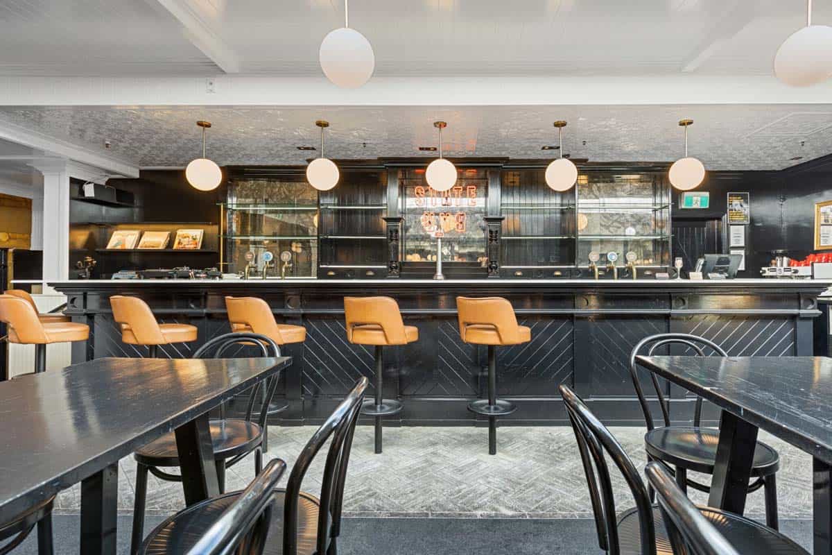 Modern bar interior at White Lion, 31 Gover Street, featuring stylish seating and lighting.