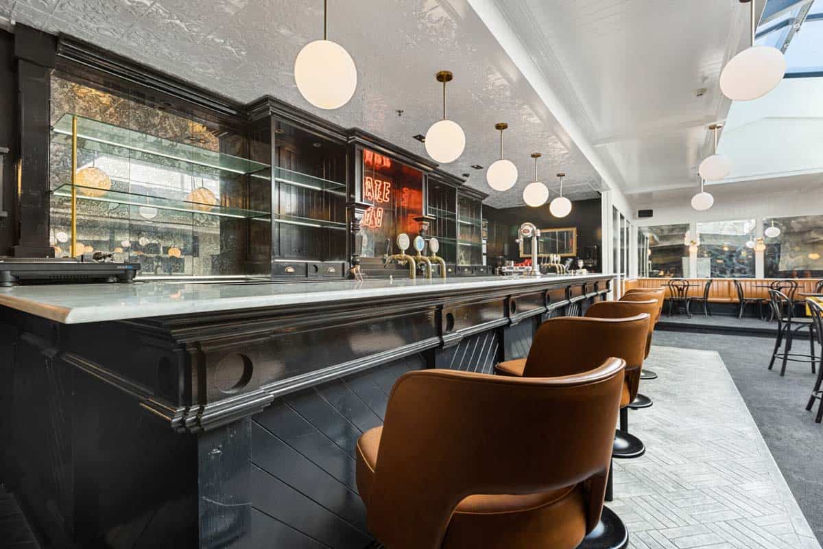 Modern bar interior at White Lion with leather chairs and ambient lighting.
