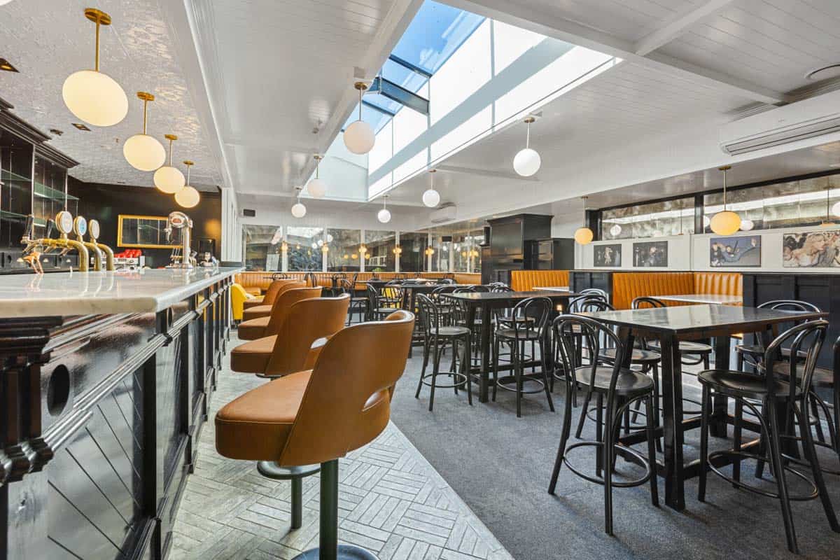 Modern bar and dining area at White Lion, 31 Gover Street, with stylish seating and natural light.