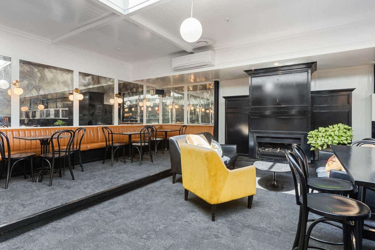 Interior of White Lion at 31 Gover Street, stylish lounge with seating and fireplace.