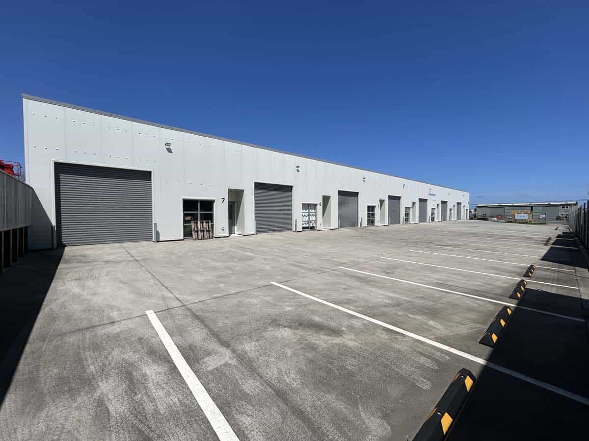 Modern industrial warehouse at Unit 4, 7 Hudson Road with large roller doors.