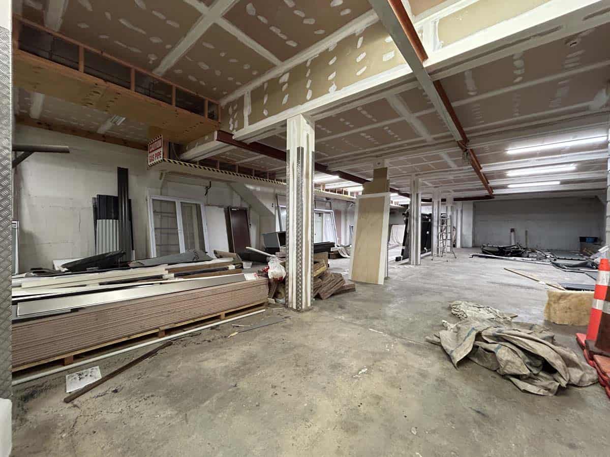 Construction site with building materials and ongoing work at 100 Gill Street.