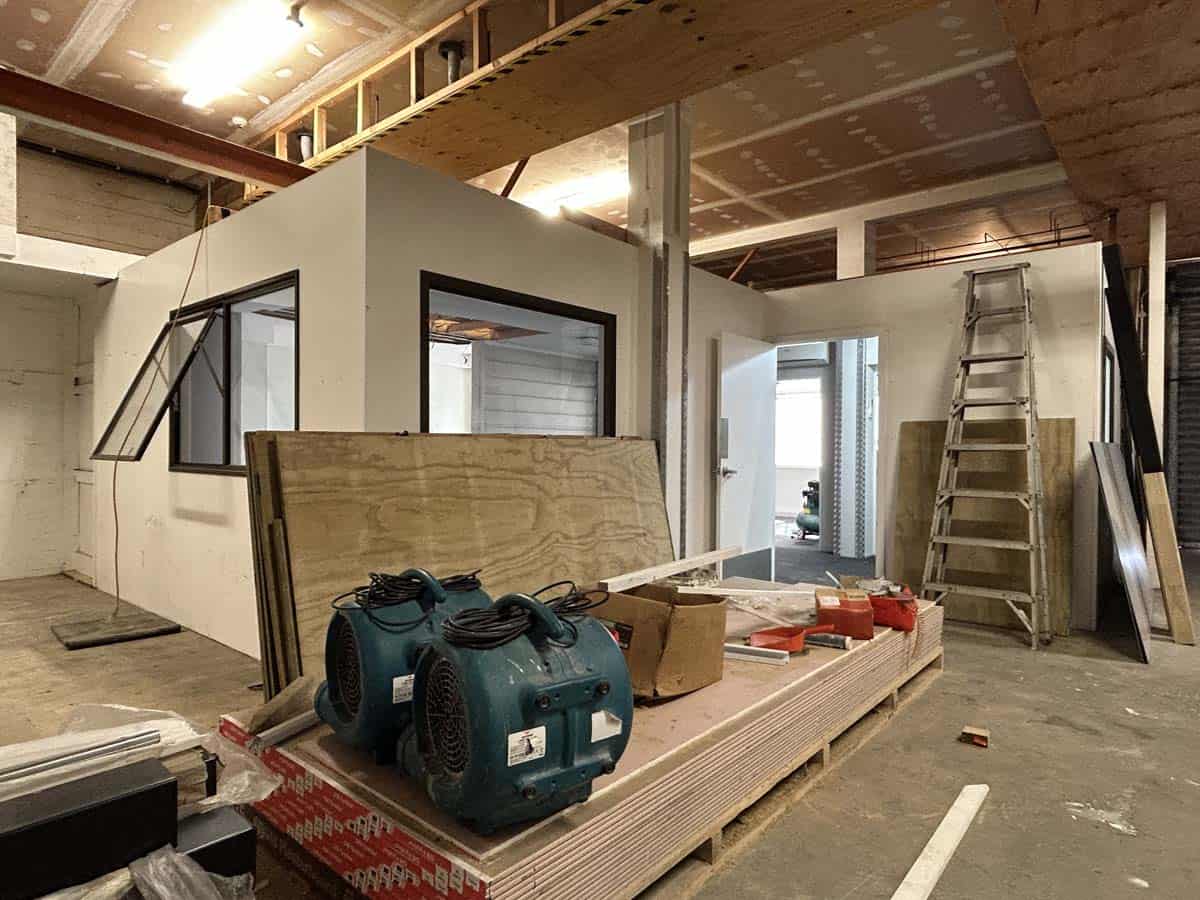 Interior view of a construction site with building materials and tools at 100 Gill Street.