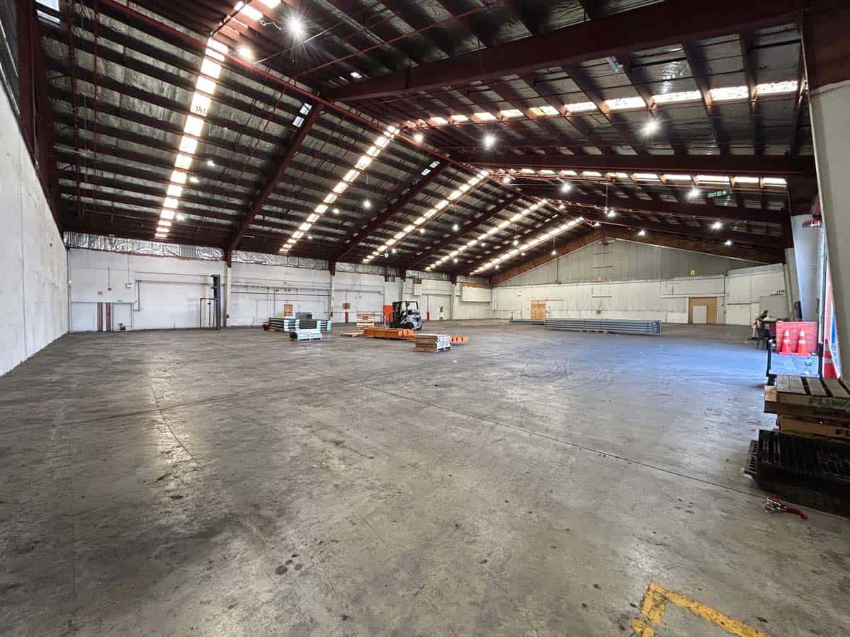 Spacious warehouse interior at White Lion, 38 East Street, with high ceilings and ample lighting.