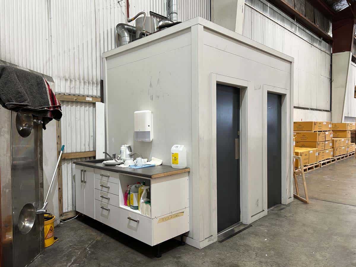 Industrial storage room with white walls and metal doors at 38 East Street.