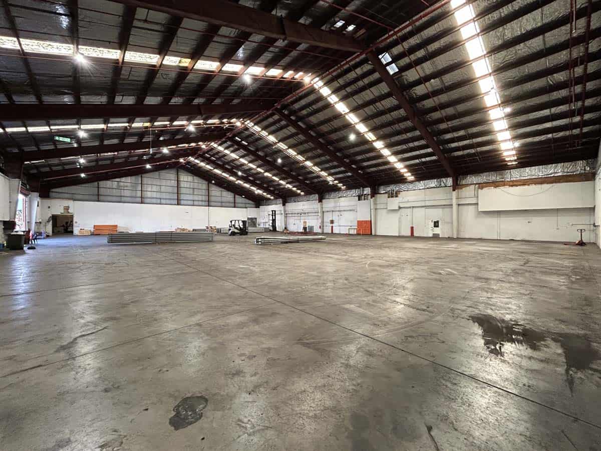 Spacious industrial warehouse with high ceilings and ample lighting.